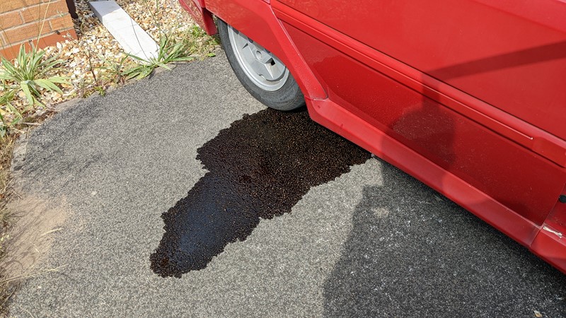 The puddle of fluid is not immediately obvious as a fuel leak