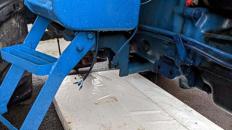 The original cab side light wiring connector is still in place on the Ford 7610.