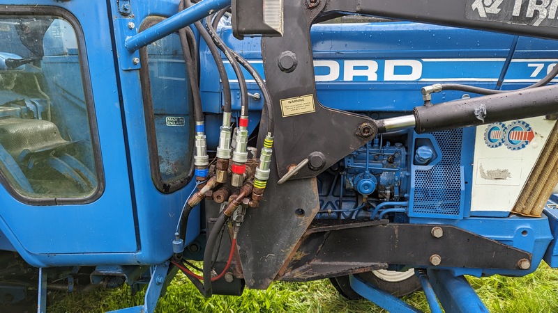 Hydraulic pipes all reconnected, and loader is mounted back on the tractor.